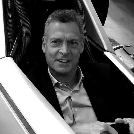 Bruce Garfield, CEO and Founder of Garfield Agency, seated in a vehicle cockpit