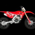Honda motocross bike in red Supreme livery, a Honda and Supreme brand collaboration