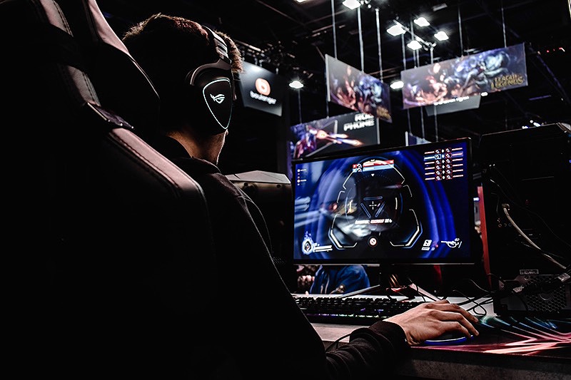 Esports player at a tournament gaming station, representing brands in video games