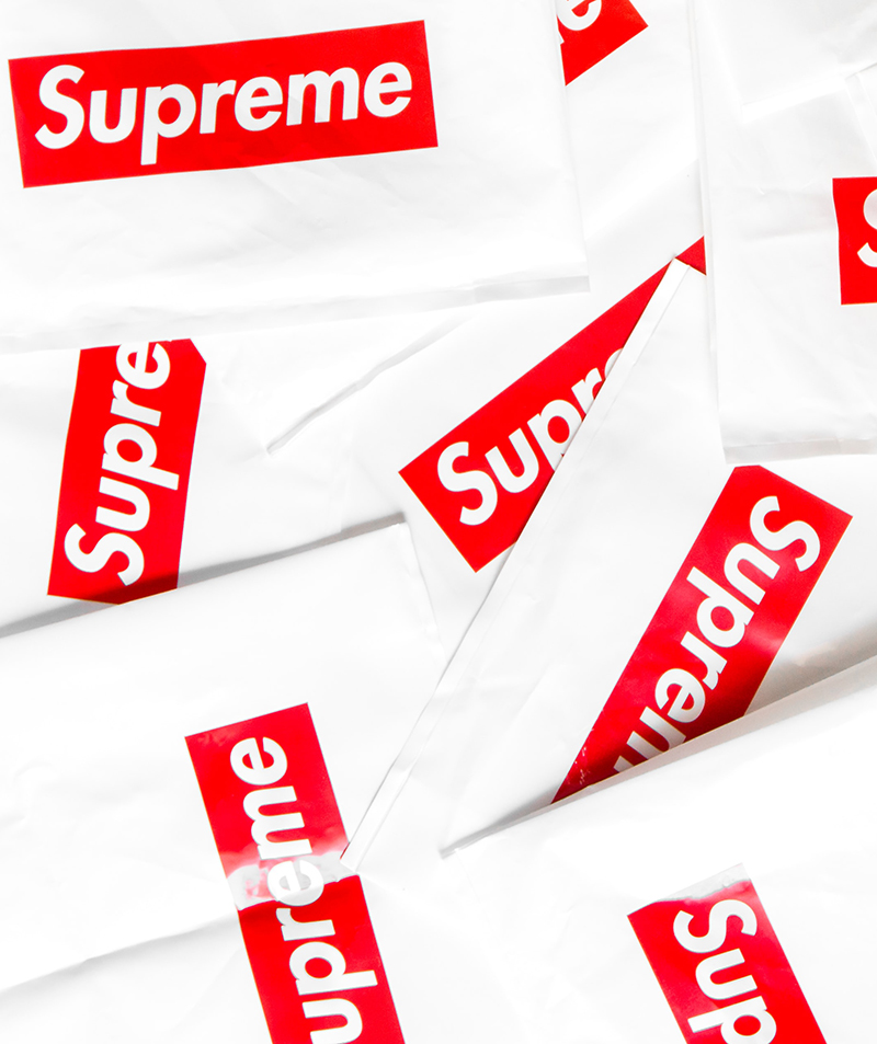 Repeated Supreme box logo on white product packaging, a trademark applied to licensed goods